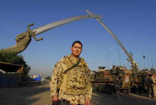 Martin Alderette in Australian desert uniform beneath the crossed swords monument in Baghdad.